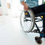Millennial Magazine - physically handicapped businessman sitting in wheelchair at office